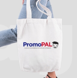 White canvas tote with PromoPAL logo held by a female walking wearing jeans