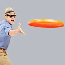orange frisbee custom sports promotional product being thrown by a male in a hat and blue shirt